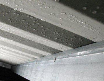 When condensation forms under metal roofs it is often mistaken for a metal roof leak (image)