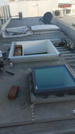 Acrylic skylight dome replacement underway with Velux glass skylight (image)